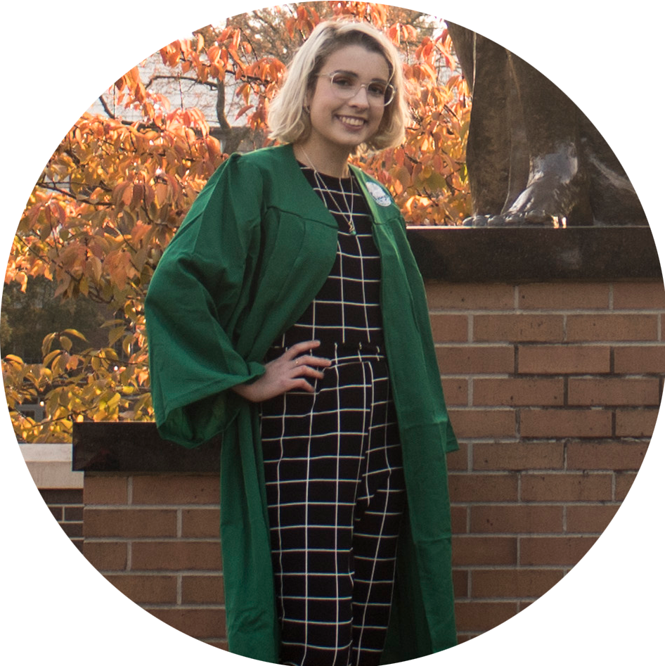 This is a photograph of Sadie next to the Sparty statue on campus