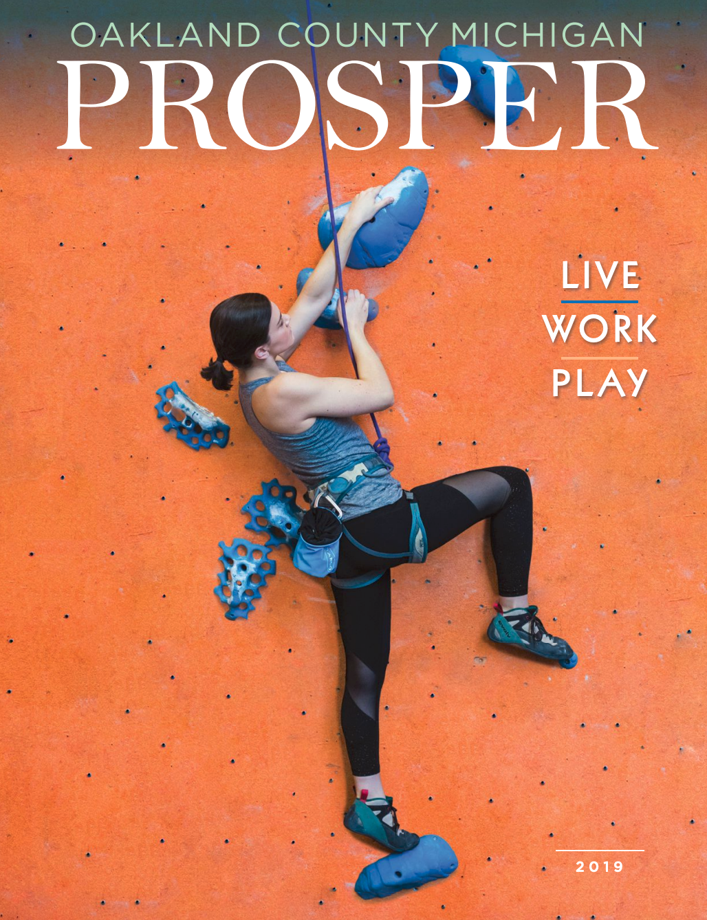 front cover of Oakland County Prosper with a woman climbing a wall